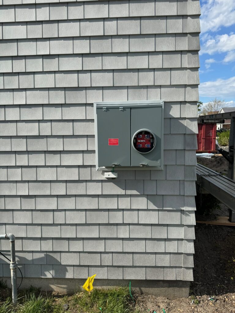 EV charger mounted on house wall.